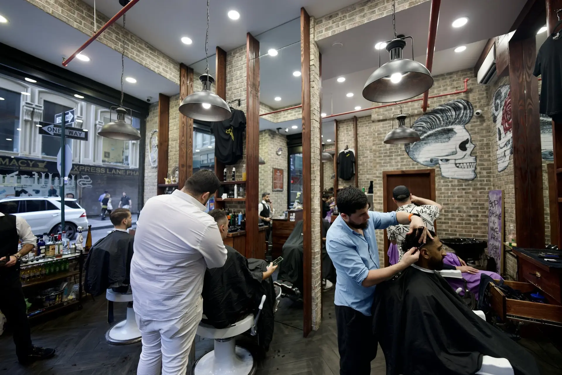 Interior of Skullfade Barbers with barbers and clients at the chairs in Lower Manhattan