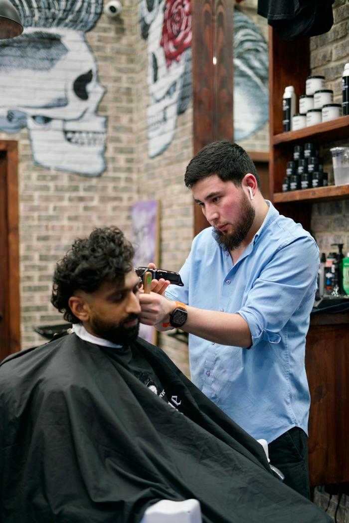 Skullfade barber at work inside the Financial District barbershop in New York